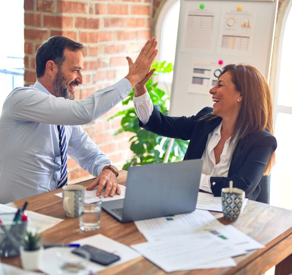 A woman and a man high-five each other