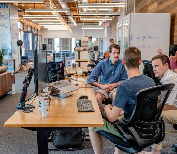 three men talking in the office